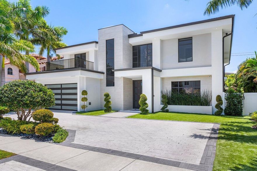 This stunning and light filled artfully designed residence is located in Boca Raton's hottest community, Boca Villas! Walking distance to Mizner Park's world class fine dinning and shopping and close to the famous Boca Raton Hotel and club, and the blue Atlantic ocean. The two story foyer introduces the amazingly beautiful open floor plan. The large modern kitchen, with views of the private back yard, gorgeous pool area with artificial turf and covered summer kitchen, features Sub Zero and Wolf appliances, butlers pantry and large center island and is open to the spacious comfortable and inviting family room. A formal dinning room, large well appointed VIP guest suite, full cabana bath and secondary laundry complete the first floor.