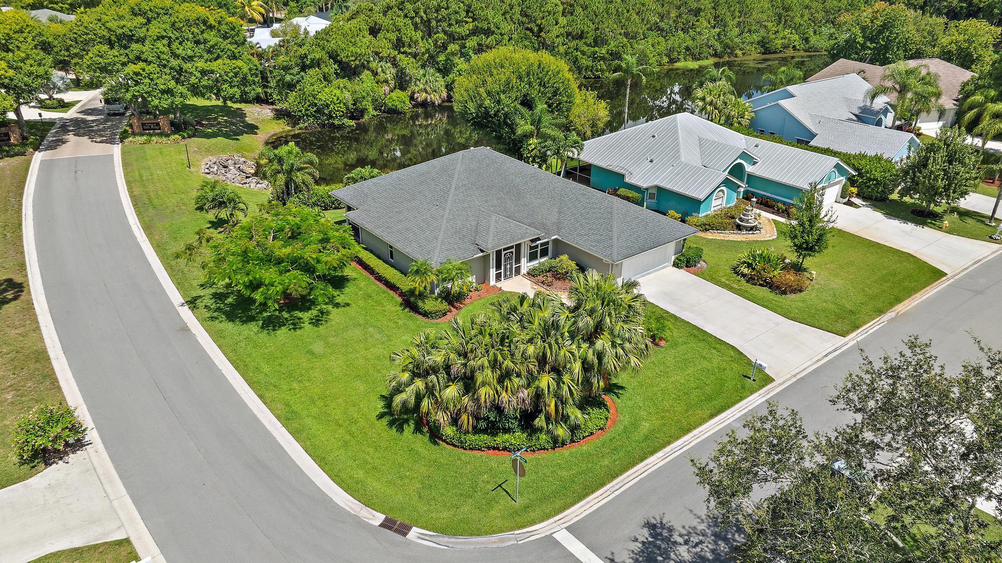 Are you dreaming of the quintessential Palm City lifestyle? Your search absolutely ends here! Discover this exquisite 3-bedroom, 2-bathroom, single-story CBS home, perfectly nestled within the highly desired Oak Ridge community. It's truly in the heart of Palm City, offering an ideal blend of convenience and tranquility.Enjoy peace of mind with impact windows & a 2016 roof. The gourmet kitchen is a chef's dream: solid wood cabinets, granite, SS appliances, and chic built-in glass shelving. Host with ease in formal & casual dining areas. Step onto your lovely screened patio overlooking a serene pond, perfect for watching ducks & wildlife with morning coffee. Immaculate landscaping on an oversized corner lot. Community perks abound: clubhouse, tennis, basketball, pool, and boat ramp!
