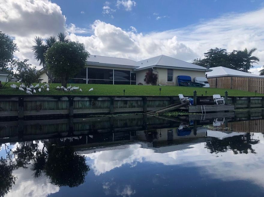 A Rare Waterfront Opportunity in Golfview Harbour. Set on the largest point lot in the community, this exceptional single-family residence offers expansive water views and direct access to three of Palm Beach County's most sought-after lakes -- Lake Osborne, Lake Eden, and Lake Ida.

Enjoy the privacy and presence of an oversized waterfront parcel with panoramic canal views and seamless indoor-outdoor living. The thoughtfully designed split floor plan offers both functionality and comfort, ideal for full-time living or seasonal enjoyment.

Major updates provide peace of mind:
Metal roof (2012)
Full-house plumbing replacement (2012)
A/C (2019)
Hot water heater (2025)
2025 appliances
Flat porch roof (2025) with lifetime warranty
Impact windows and doors
Accordion shutters/sliding Interior painting (2025) Exterior of house painted (2025) Complete air duct replacement (2020)                              
Additional highlights include vaulted ceilings, a two-car garage, expansive driveway, and direct access to Caloosa Park through the neighborhood. Irrigation system draws from the canal, keeping water bills low. 
Located just 10 minutes from the beach, this property offers the freedom of no HOA and no restrictions -- bring your boat, RV, and recreational vehicles with ease. Well maintained and ready for your personal vision. A wonderful opportunity to update and create a modern masterpiece tailored to your style. Investors welcome, no rental restrictions.
Offered furnished/furniture negotiable, including two kayaks for immediate enjoyment of the lake lifestyle. Listing Agent is the Owner.