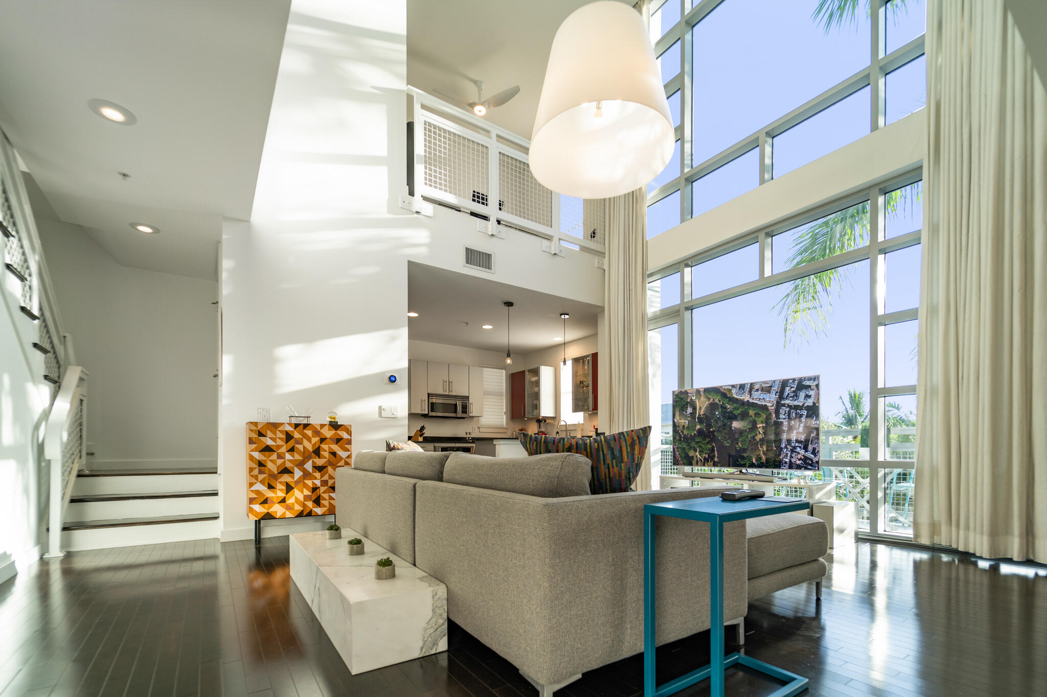 Rare two-story corner penthouse in the heart of Delray Beach. Fully furnished for turn-key luxury living. This 1587 sqft west facing unit features a water tower view with gorgeous sunsets through its 20ft floor-to-ceiling impact windows. Expansive bright and open floor plan. Two terraces finished in new Italian porcelain allow for al fresco dining and lounging. Second bedroom loft is currently configured as the perfect work from home office. One of the largest modern contemporary condos available in all of Delray Beach. Only 3 short blocks to Atlantic Avenue and only a 10 minute walk to the beach. Includes two dedicated parking spots (one in the gated garage) and two storage units