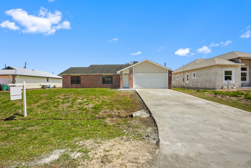 Welcome to this beautifully updated 3-bedroom, 2-bathroom home offering over 1,700 sq ft of move-in ready living space in a convenient Port St. Lucie location. Situated on a spacious lot, the property features a large backyard with plenty of room to relax, entertain, or customize to your liking.  The interior has been fully updated, showcasing a modern design throughout. The kitchen features sleek quartz countertops, updated cabinetry, and a clean, contemporary feel that flows seamlessly into the main living areas. Both bathrooms have been tastefully renovated, and new flooring runs throughout the home, creating a cohesive and stylish look. Additional features full impact windows, along with a 220-volt outlet suitable for electric vehicle charging.  This home offers the perfect blend of comfort, style, and functionality—truly move-in ready. Schedule your showing today!