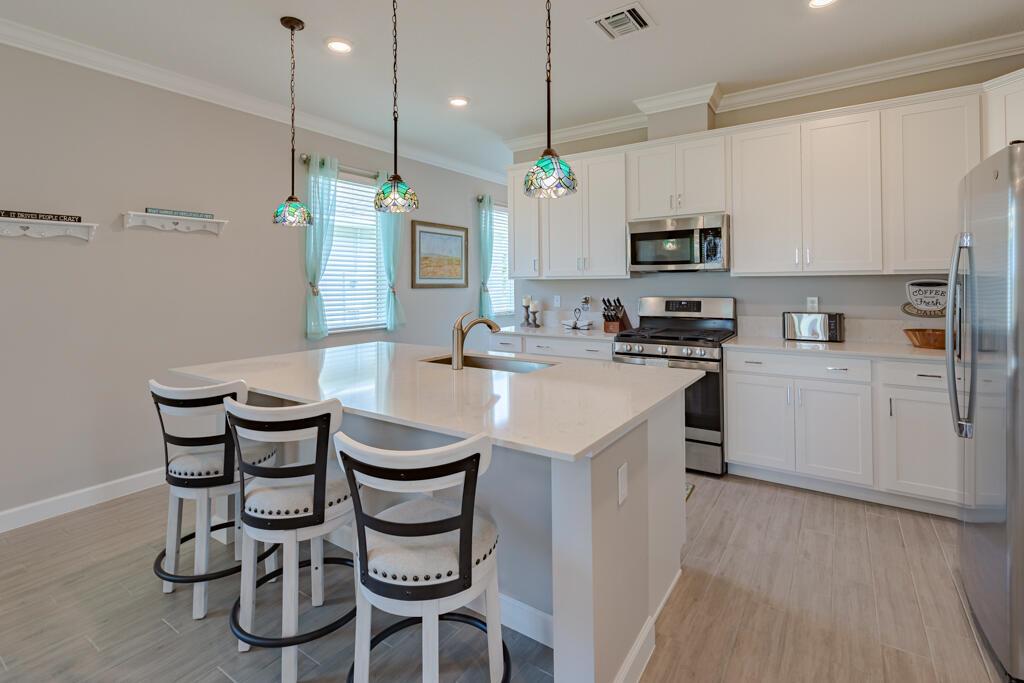 Awesome 55+ Community! Immaculate 3/2/2 home within gated, vibrant Veranda Preserve. This MOVE-IN READY gem sits on a huge pie-shaped cul-de-sac lot with ample room for a pool and backs onto a peaceful preserve. Inside, discover a gourmet open kitchen w/ quartz countertops, SS appl, GAS range, and large island. The open-concept dining and living areas boast 9-foot ceilings, flowing out to a covered lanai with brick pavers and a GAS BBQ hookup. Plank wood look tile flooring throughout, crown molding, ceiling fans, & IMPACT glass for worry-free living. Resort-style clubhouse offers a heated pool/spa, movie theater, cafe, fitness center, yoga studio, card room, tennis, pickleball and activities. Unbeatable location near I-95 and Tpk. Some Furniture Negotiable.
