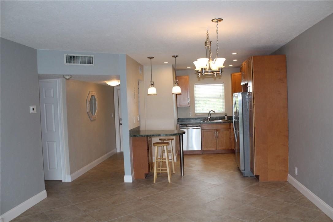 Lovely, remodeled 2 bedroom on the water in Coral Ridge Isles. Nestled among $1M+ single family homes at the end of cul-de-sac street. Serene water views from living room and screened-in balcony! Third floor elevator building with no neighbors above! Neutral tile on the diagonal, laminate wood flooring in bedrooms. Second bedroom has its own entry. New energy efficient A/C (2025). Water included. Open kitchen design with KraftMaid wood cabinetry, newer refrigerator. Washer & dryer in unit. Additional storage included. Pool overlooks canal with BBQ area. One mile to Pine Crest School! Conveniently located to nearby shops, restaurants and major hi-ways. Three miles to the beach! No pets please.