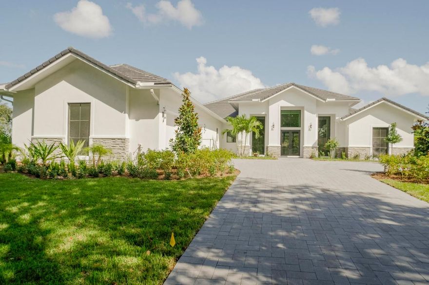 45 days away from completion!! Brand New Construction, never lived in custom estate on a rare, 1-acre corner water lot. This showstopper offers 5BR + office, 6.5 baths, with nearly 5,000 living square feet. The mid-century modern design includes Italian porcelain and wood flooring, plus a spacious kitchen with ultra high-end features including induction or gas cook top, double oven, and top of the line Sub-Zero & Wolf appliances. The primary suite offers a dual walk-in shower with separate free standing soaking tub, dual vanities, and separate make-up area. All bedrooms will feature their own en-suite bathrooms. The backyard will feature a custom heated pool/spa with built-in summer kitchen.