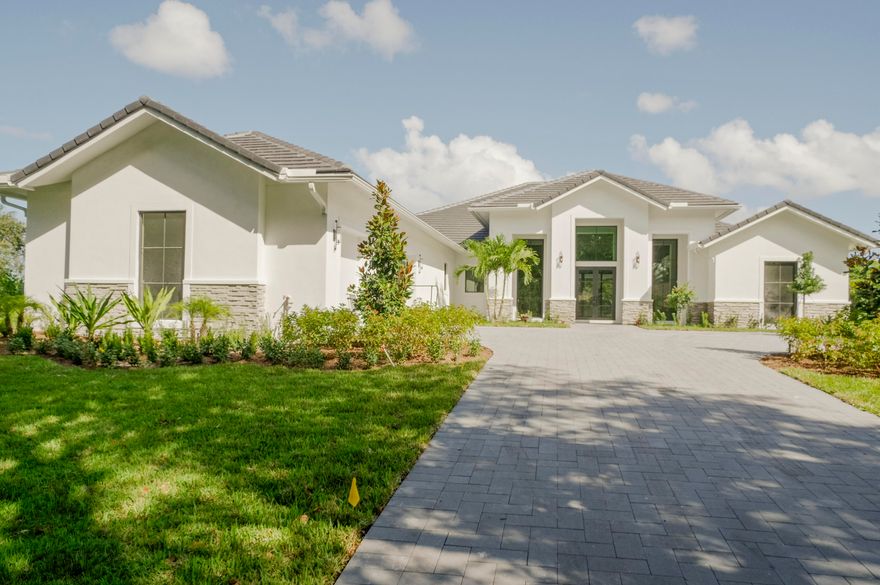 45 days away from completion!! Brand New Construction, never lived in custom estate on a rare, 1-acre corner water lot. This showstopper offers 5BR + office, 6.5 baths, with nearly 5,000 living square feet. The mid-century modern design includes Italian porcelain and wood flooring, plus a spacious kitchen with ultra high-end features including induction or gas cook top, double oven, and top of the line Sub-Zero & Wolf appliances. The primary suite offers a dual walk-in shower with separate free standing soaking tub, dual vanities, and separate make-up area. All bedrooms will feature their own en-suite bathrooms. The backyard will feature a custom heated pool/spa with built-in summer kitchen.