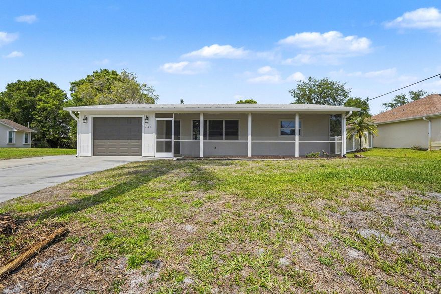 This sun-washed Sebastian ranch delivers what Florida living is really about: a sprawling screened porch with a wood-plank ceiling and ceiling fan, a fully fenced backyard with room to roam, and a freshly updated interior ready for day one. Inside, luxury vinyl plank floors run through light-filled living spaces anchored by a beadboard ceiling and a built-in white entertainment wall. The kitchen shines with white cabinetry, marble-look countertops, and stainless steel appliances. Bedrooms feature crown molding and generous closets; a dedicated laundry room adds everyday ease. Zoned for Sebastian River High School and minutes from Sebastian Inlet State Park, Riverview Park, and Captain Hiram's waterfront dining. Three beds, two baths, and a lifestyle that's hard to beat.