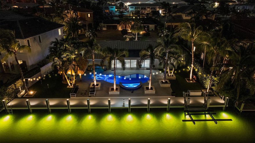 Experience coastal luxury on 110 ft of deepwater in prestigious Lighthouse Point! This reimagined waterfront home spans 2,254 sqft with 3 bedrooms & 3 baths, blending timeless design with modern sophistication. Interiors feature a designer kitchen with quartz counters, custom cabinetry, & Thermador appliances. Outdoor living is unmatched, boasting a new 110' concrete dock raised to 5.0 NAVD, underwater dock lighting, a resort-style pool with sun shelf and spa, putting green, & tiki hut for effortless entertaining. Additional features include impact windows & doors, a metal roof, SWAT mosquito system, & 2-car garage. Ideally located just 1.2 nautical miles 1.5 nautical miles to the open ocean thru the Hillsboro Inlet, this residence defines the ultimate South Florida waterfront lifestyle!