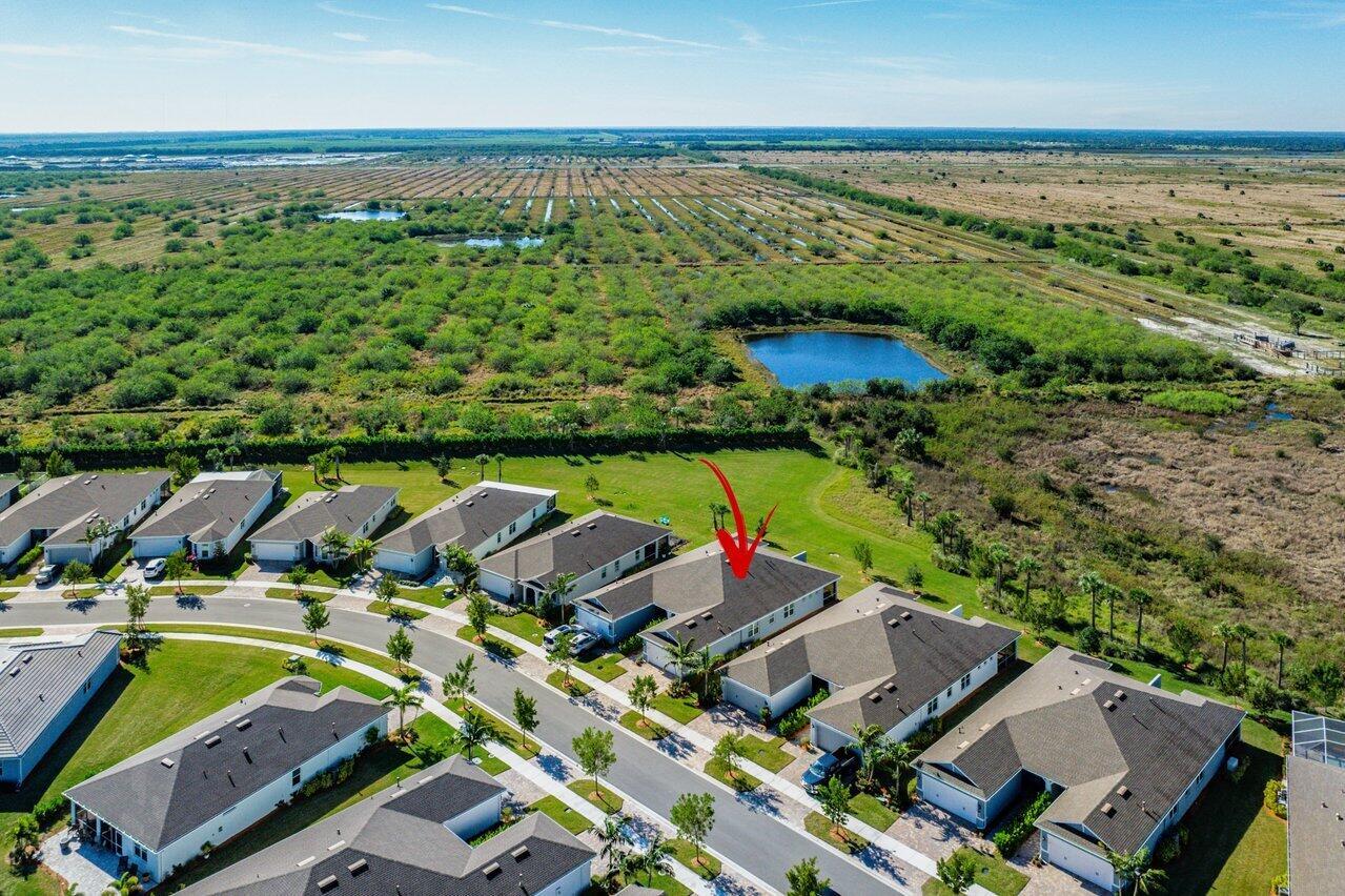 Discover this stunning 3-bedroom, 2-bath CBS villa with a 2-car garage, ideally set on a tranquil preserve lot in the gated 55+ community of Del Webb at Traditions. Built in 2022, this home offers an open-concept design with modern finishes and thoughtful upgrades throughout. Beautiful faux-wood tile flooring spans the entire home. The gourmet kitchen features 42'' soft-close cabinets, granite countertops, a spacious center island, gas stove, tiled backsplash, and stainless-steel Whirlpool appliances. The primary suite provides a peaceful retreat with a walk-in closet and spa-like bath including dual sinks, Silestone counters, Moen fixtures, and a glass-enclosed shower. Additional highlights include impact windows with plantation shutters, automatic blinds, a spacious laundry with sink...