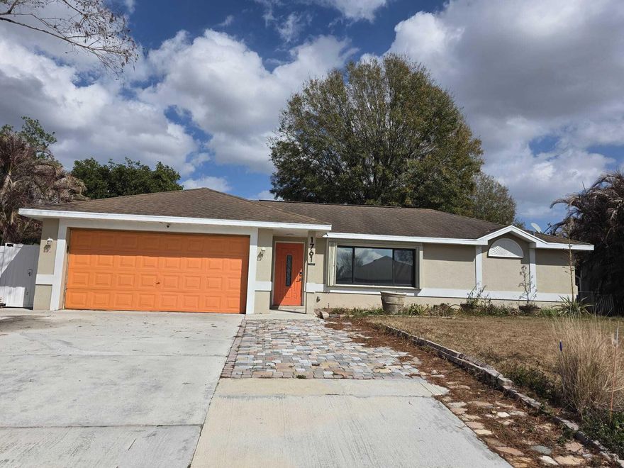 Welcome to this versatile home in Port St. Lucie, Florida, offering flexible living spaces and a layout full of character. Featuring 3 bedrooms and 2 baths, plus a converted garage apartment with its own private entrance, bathroom, and kitchenette perfect for guests or extended family.  Step through the foyer with French doors into a spacious tiled great room, which flows into a separate family room accented by wood flooring and a stylish barn door creating defined yet connected living areas. The split floor plan provides added privacy. The kitchen comes equipped with appliances and solid wood cabinetry. Outside, enjoy a fenced backyard with lots of potential to create your perfect relaxing oasis. This home is perfect for buyers seeking flexibility or multi-generational living options.  Room sizes are approximate and should be independently verified by buyer.