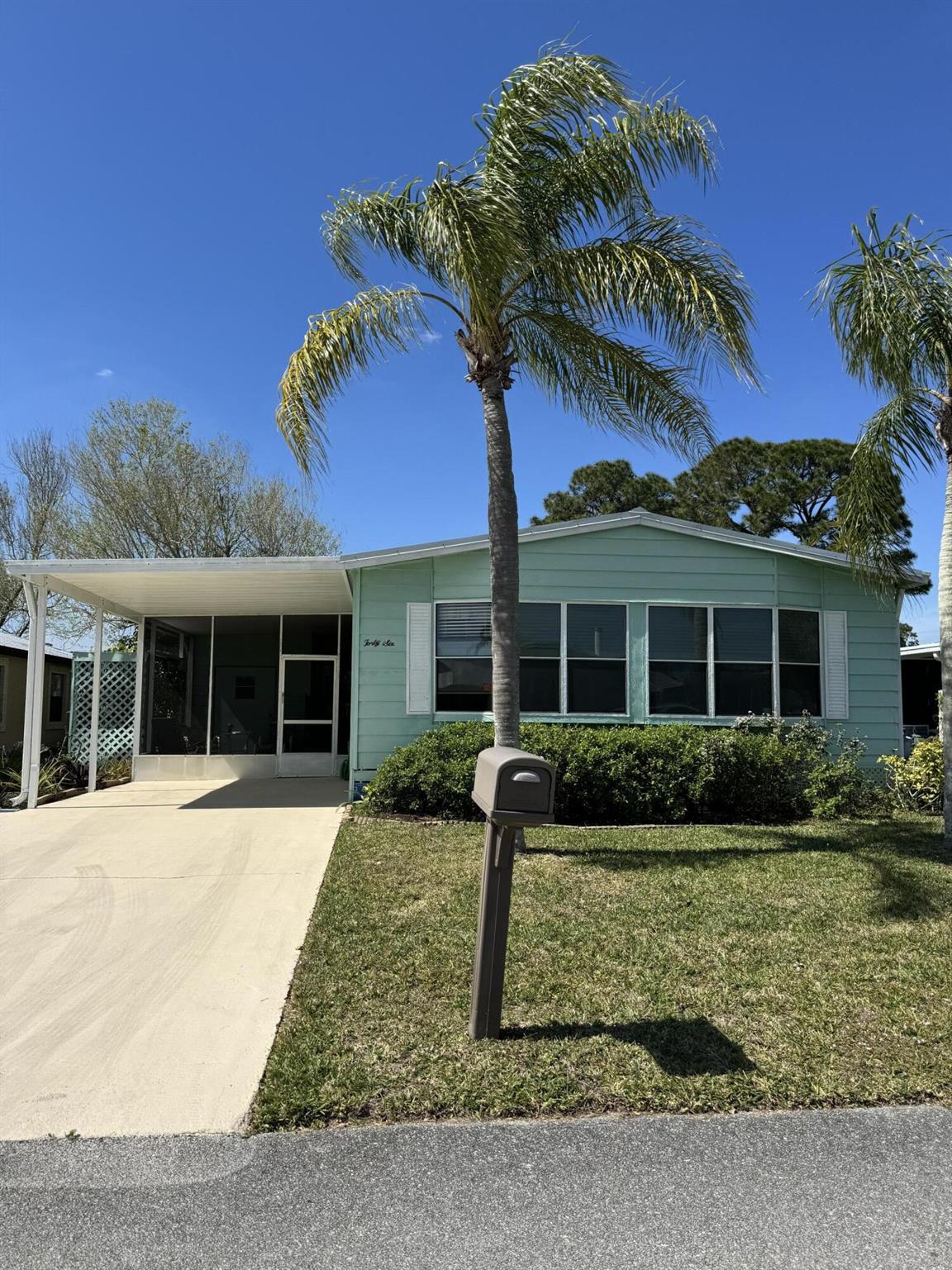 MOTIVATED SELLER! WANTING A QUICK SALE! Lake view home. with 2 bedrooms and 2 baths with an oversized Florida room. The home has a metal roof replaced in 2022 with a 30-year warranty. A/C replaced in 2021. New vanities in bathrooms. The primary bathroom has a walk-in shower. The home is being sold as partly furnished. Has no carpet. Screened porch in front of the house and a Florida room in the rear of the home. Nice size storage/tool room off the screened-in porch. Fruit trees in the yard. Spanish Lakes is a 55+ community with tons of amenities.