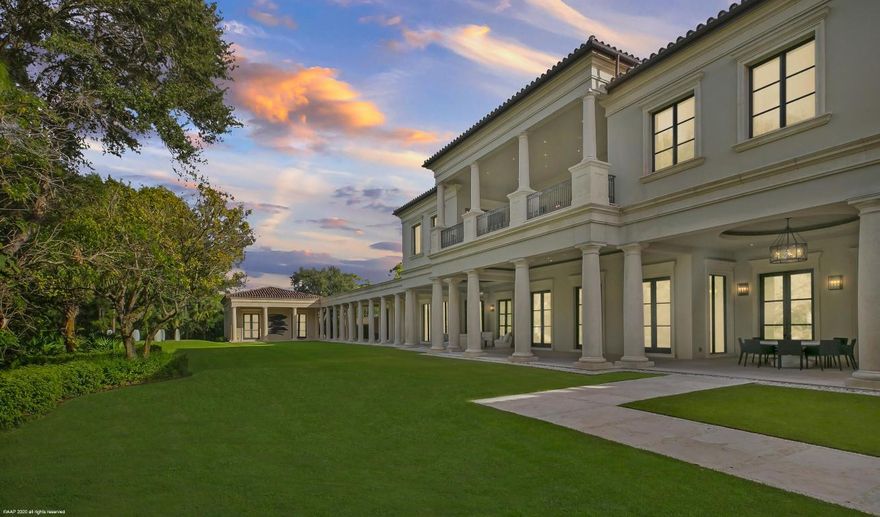 Situated on an oversized double  lot in the The Bear's Club, this custom Palladian styled estate residence offers 33,705 total square feet with 7 bedrooms, 9 baths and 3 half baths. The property offers spectacular views of the 11th and 12th  fairways of the Nicklaus signature golf course from its expansive outdoor loggias, galleries, manicured lawn, elegant pool and spa and covered private second floor terrace. This residence was originally designed by architect Manuel J. Diaz and was built by Lavelle Construction. The property has been previously featured in Architectural Digest. The main house offers bespoke finishes and extraordinary attention to detail throughout including high ceilings and doors, custom moldings and built-ins, marble floors, beautifully proportioned rooms, a full house generator, hurricane impact doors and windows and the most spectacular master suite with a dressing room, safe room, gallery hall and a sensational bathroom that serves as a spa-like retreat. In addition to the main residence the property features a spacious free standing office conveniently located next to the master wing complete with an en-suite bath, walk-in closet and a large gym surrounded by floor-to-ceiling windows showcasing the beautiful garden and golf course views. There is also a separate two-story guest house with an office, two bedrooms and two baths, and a living room, kitchen, and laundry.