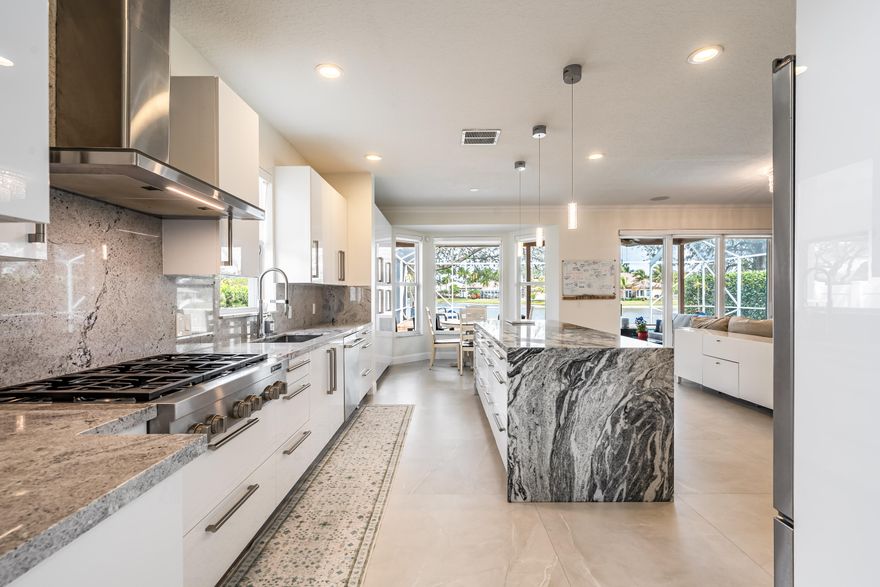 Beautifully updated lakefront 2-story Kingston model in sought-after Pembroke Falls featuring 4 bedrooms, 3.5 baths plus expansive loft and a 3-car garage with built-in storage. Interior highlights include 3x3 porcelain slab floors, bamboo flooring upstairs, wood staircase with modern metal railings, and impact glass throughout. The granite kitchen features stainless steel JennAir appliances and gas range, opening to the family room with surround sound. The first-floor owner's suite offers pool access, dual walk-in closets, and a spacious spa-style bath with soaking tub. Outside, enjoy a fully fenced yard with a screened pool and spa with stunning, expansive wide-water lake views, perfect for relaxing or entertaining while enjoying South Florida living at its best.