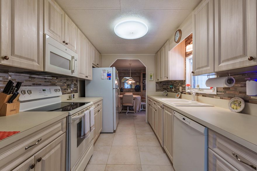 Private Yard for Grill, Garden, Bird Watching, Dog Play & more! Furnished 2bed/2bath w/ a RAMP for easy access or opt to use the steps. Great outdoor Lot w/ a SHED has a tropical vibe - great for privacy & activities. Beautiful, well lit, enclosed Patio/Florida Rm w/ AC & Storm Shutters double as an extra room/den/office & more! Master bedroom features an en-suite bathroom & both bedrooms offer generous closet space. AC 2022. PRIME LOCATION; close to the beach (but NO FLOODZONE), the mall, grocery stores, diners, coffee shops, post office, banks, pharmacy, hospitals & more. Lot lease 930.98 includes lawn care, trash, private, free golf course, heated pool, pickleball, tennis, shuffleboard, bocce, gym, library, cards, Mahjong, bible study, wood workshop, dinners, parades, dances & more!