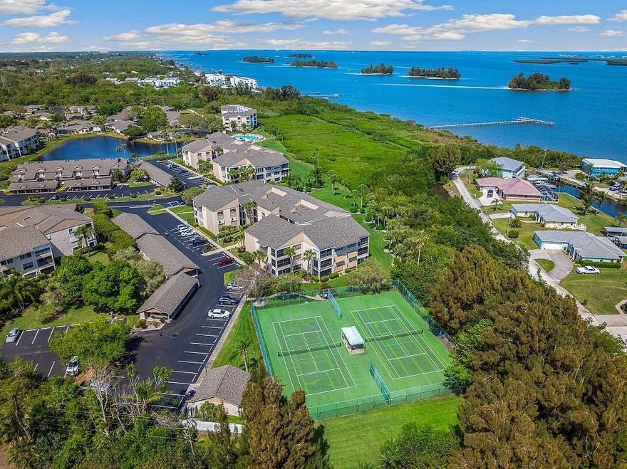 Picture yourself in this rare 3BR/2BA first-floor condo in Reflections on the River, w/Intracoastal views from your Florida room! Enjoy meal prep in the modern kitchen w/cooktop, wall oven, stainless appliances & custom cabinetry accented by granite counters & stylish backsplash. Plus tiled flooring throughout, tiled bathroom showers w/glass doors, built-in wall storage in second bedroom, pull-down shades for living room & enclosed porch, newer water heater, brand-new building roof & personal carport. Community pool, clubhouse, marina w/free dockage & more. Convenient to shopping, restaurants.