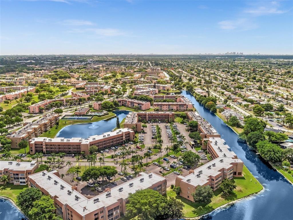 Stunning Corner Unit Condo with Wraparound Water Views in a 55+ Community! Enjoy breathtaking water views from every room in this 2-bedroom, 2-bathroom corner unit, featuring all impact windows for safety & peace of mind. The enclosed balcony adds extra living space, perfect for relaxing & soaking in the views. This unit boasts brand-new laminate flooring, new blinds, & an updated kitchen with brand-new appliances. Residents enjoy resort-style amenities, including a heated pool, jacuzzi, sauna, billiards, bingo, theater, comedy shows, shuttle bus, tennis, golf, outdoor pools, & more. Cable & water are included in the HOA! Prime location with easy access to shopping, restaurants, the airport, cruise port, parks, beaches, & major highways. Service animals only. No leasing allowed. Video Tour