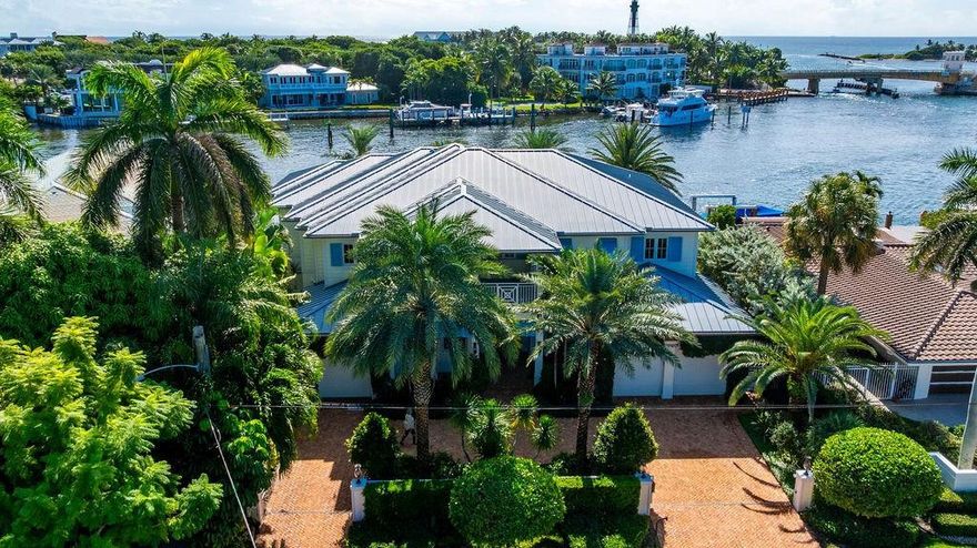 Directly on the Intracoastal and overlooking the Atlantic thru the Hillsboro Inlet bridge, this magnificent Summit built home, defines waterfront living at its finest.  The views greet you upon entering the house and carry through to the backyard where you can enjoy the blue waters of the ocean daily. Designed with modern coastal elegance, this 5br/6ba home, with open living spaces and seamless flow incl clubroom/office, upstairs family room, awesome primary BR w/double closets/ lg bath , 2 laundry rms, elevator, covered lanai and  open balcony, offers timeless design and panoramic vistas. Plus 100+ft of waterfront with no setbacks, gated entry, Chicago brick circular drive 3 CG w/ addl storage,  and lg pool with integrated spa surrounded by stone pavers, complete this exceptional home.