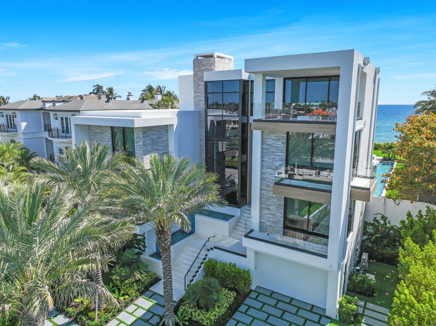 Experience the pinnacle of luxury living in this exceptional, MOVE-IN-READY residence that blends sophisticated design with cutting-edge features. This turnkey property offers an unmatched lifestyle, with breathtaking panoramic views of both the private ocean and Intracoastal waters surrounding the entire estate. Wake up each day to a serene waterfront horizon in a home that truly defines elegance and exclusivity. This brand new built home is being sold TURN-KEY, so simply bring your clothes and personal items.  999 Hillsboro is built like a fortress using the latest building code with waterproofed concrete exterior and hurricane resistant impact doors/windows. The matching porcelain exterior complements the 74-foot lap saltwater pool, making this home not just a place to live, but a