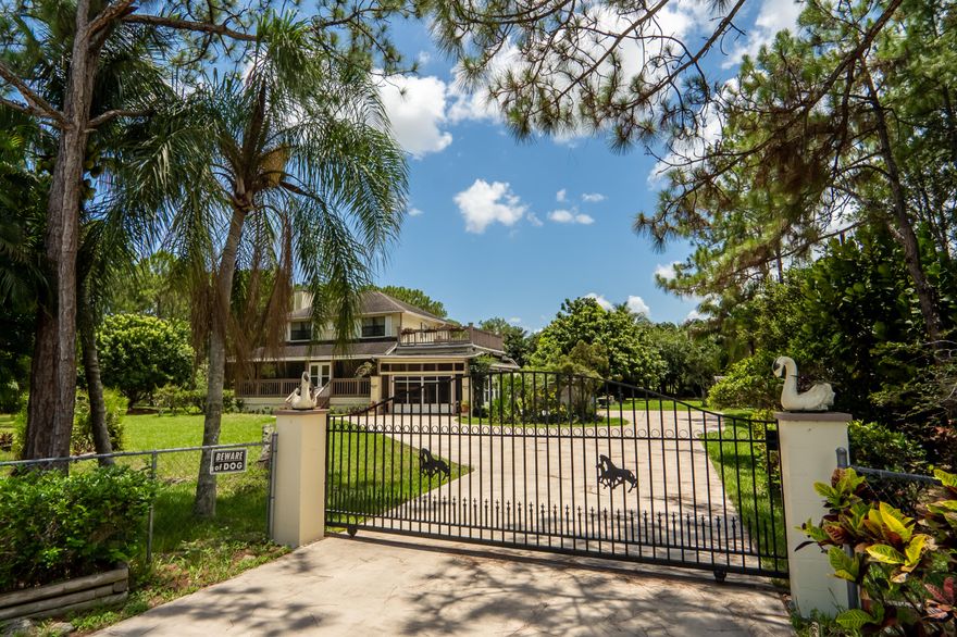 Four bedroom, two-and-a-half bath, two-story home on 1.15 acres of truly lush, landscaping and a PAVED ROAD! Over 18 fruit trees! Beautiful fence and gate, fireplace, too many storage rooms to count! Huge, second- level balcony/deck off master. Multiple, screened enclosures all around this home! Gardner's dream featuring the following trees: 2 Neasberry, Lychee, Longon, EIGHT Mango, Coconut, Ackee, Jamaican Plumb, Soursop, Applee, and Tambrind! Bring your horses, pets and RV's! This is what living in Loxahatchee is all about! Come see today! All room sizes approximate.