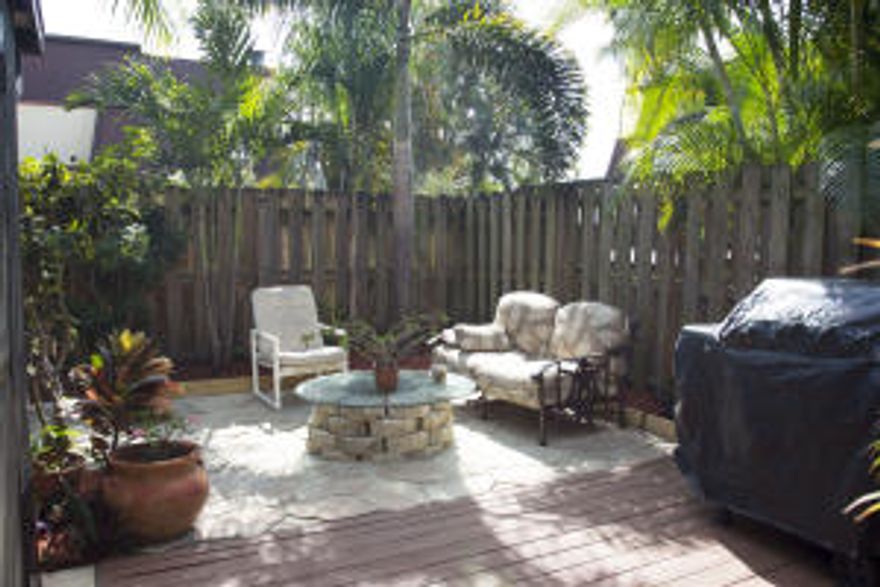Well maintained townhouse in the heart of PBG across from the PBG Medical Center. As you enter the property, it offers a tropical outdoor lounge with full privacy. Newer carpet with all knockdown ceiling downstairs. Beautiful faux stone fire place in the living room, clean kitchen, two screened in patios upstairs and down. A/C replaced in 2014, fresh paint inside and out.  Low HOA, close to everything and great for investors rent about $1500 a month. Come take a look at this great opportunity.