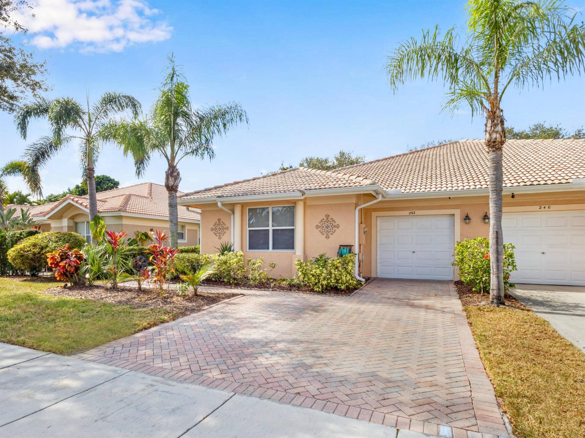 Stunning 3-Bedroom, 2.5-Bathroom Villa with Gorgeous Upgrades and Prime LocationThis immaculate 3-bedroom, 2.5-bathroom villa offers a spacious and open floor plan, featuring neutral ceramic tile floors throughout and vaulted ceilings that create a light, airy atmosphere. The home includes a large living room and dining area, perfect for entertaining. The main bedroom boasts a walk-in closet and an en-suite bath with double sinks. Enjoy the convenience of a newer washer & dryer, 3 ceiling fans, and central A/C and heat.The exterior showcases lush landscaping and a large patio with a screened lanai--ideal for outdoor entertaining. A brick driveway completes the property's charm.Prime Location: Just minutes from downtown Delray Beach, known for its beautiful beach,
