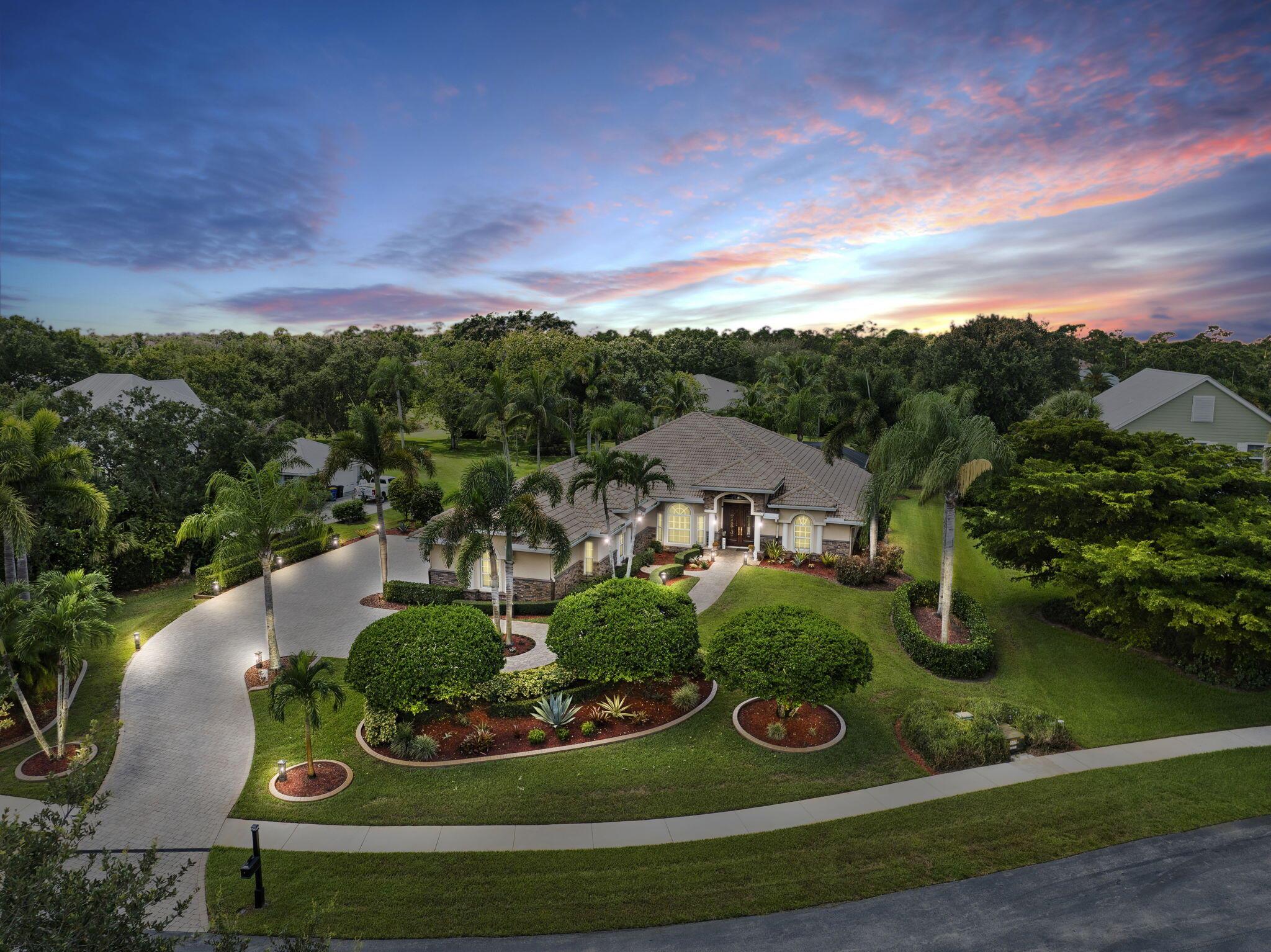 Welcome to 5416 SW Coral Tree Ln, a Tuscan style CBS home featuring 3 beds, 2 bath, + den, spanning 2639 sqft, complete with a 3 car garage, & situated on .62 acres. The backyard oasis is perfect for entertaining, featuring a stunning saltwater pool, serene waterfall, sundeck, covered patio, & lake views. The chef's kitchen is a dream with 42-inch cabinets, granite countertops, large center island, tumbled marble backsplash, & new appliances. Upgrades include newer A/C, new HW heater, epoxy garage floors w/ shelving, extended paver driveway/walkway, remote irrigation & landscape lighting. All in the highly desirable Orchid Bay of Palm City. Amenities include tennis, pickleball, basketball, playground, & volley ball court. Close to A+ schools, dining, shopping, beaches, 95/turnpike.