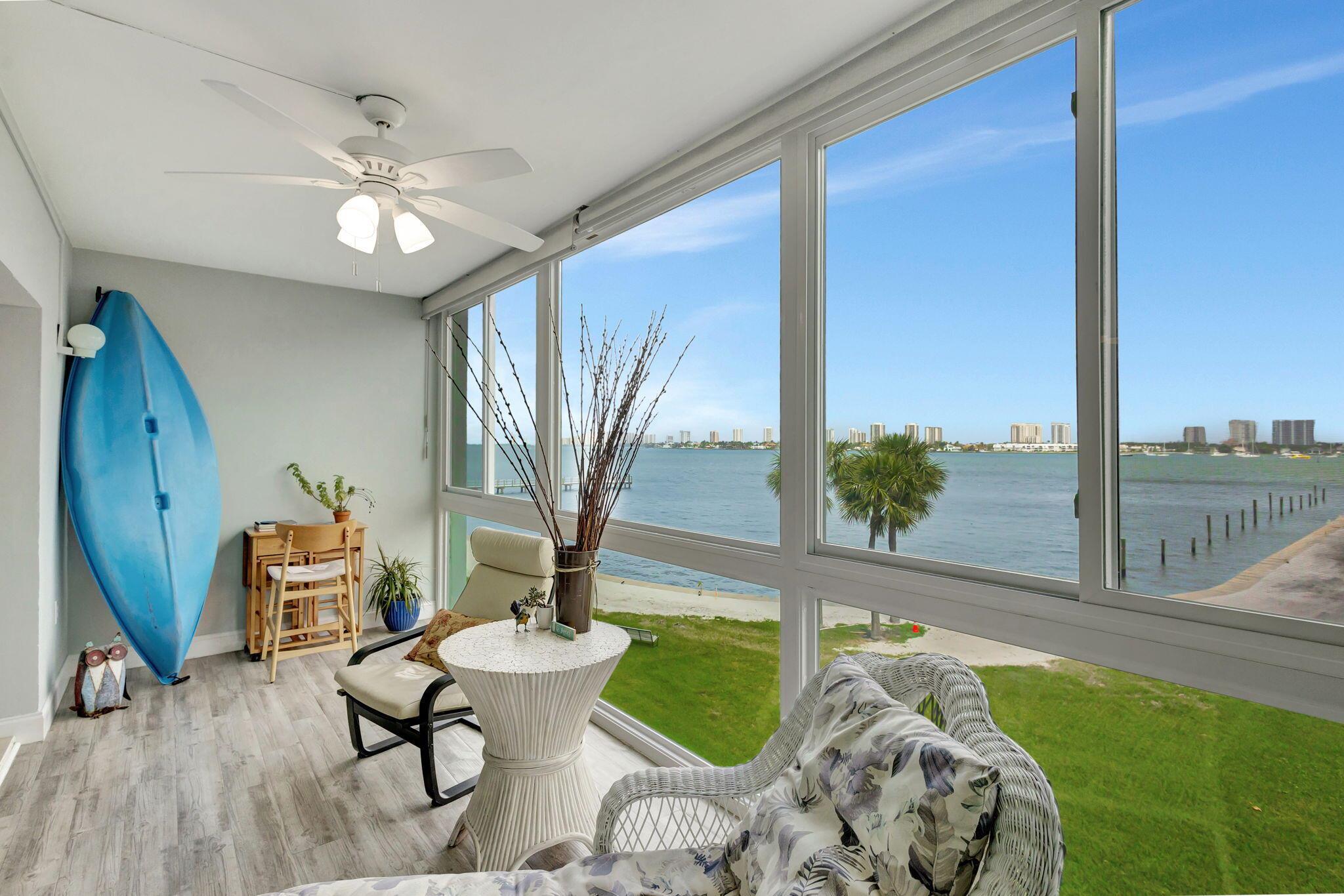 Enjoy spectacular Intracoastal water views from living room and glass-enclosed lanai. Newly installed impact windows (2023). Many updates include: new air conditioning system (2023), water heater (2024), wood laminate and tile flooring, modern kitchen counters, cabinets, appliances,. New roof to be installed. Seawall restoration in progress, Property is EZ to show.