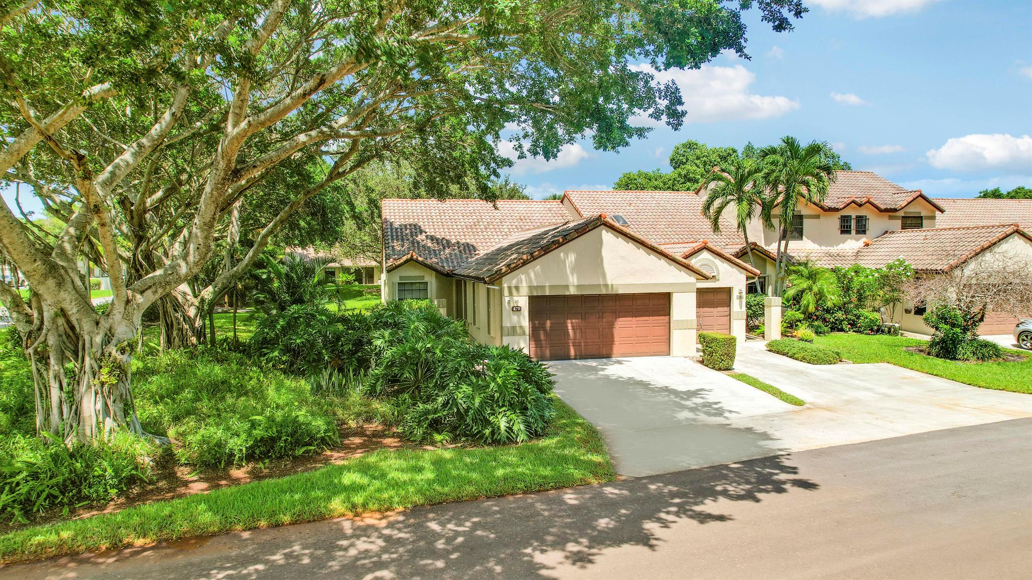 Nestled in a lush setting near a 20-acre lake with scenic trails, this 3 bedroom, 2 bath, 2 car garage villa offers the perfect combination of privacy and convenience. Inside, you'll find a bright open floor plan with vaulted ceilings, split-bedroom design, tile flooring throughout, and a large primary suite with patio sliders. The eat-in kitchen, screened patio, and in-unit washer/dryer add to the comfort and functionality. Community amenities include a 24-hour manned gate, 2 swimming pools, dog park, BBQ picnic area, tennis, basketball & racquetball courts, and jogging/biking trails. All just 1.5 miles from the beach and close to FAU, Mizner Park, Atlantic Ave, with easy airport, Tri-Rail & Brightline access. Zoned for top-rated schools.