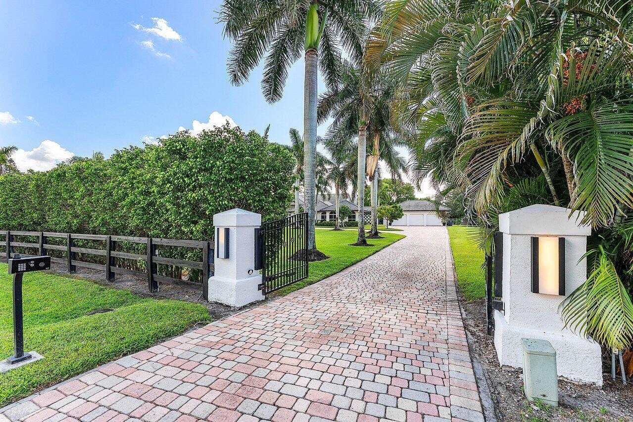 Welcome to your dream oasis in the heart of Wellington's prestigious equestrian community! This stunning, fully updated, one-of-a-kind home boasts 7 bedrooms plus a den, loft, and bonus room, offering unparalleled space and luxury. With 6 total baths, including 4 baths in the main home and 2 bedrooms and baths 2 in the guesthouse, this residence provides ample comfort and privacy for family and guests.Upon entering, you'll be greeted by tasteful decorative touches throughout, accentuating the home's modern elegance. The spacious layout seamlessly integrates indoor and outdoor living, with full impact windows inviting abundant natural light and offering picturesque views of the sprawling 2.69-acre property.Step outside to your brand new outdoor entertainment area, where luxury
