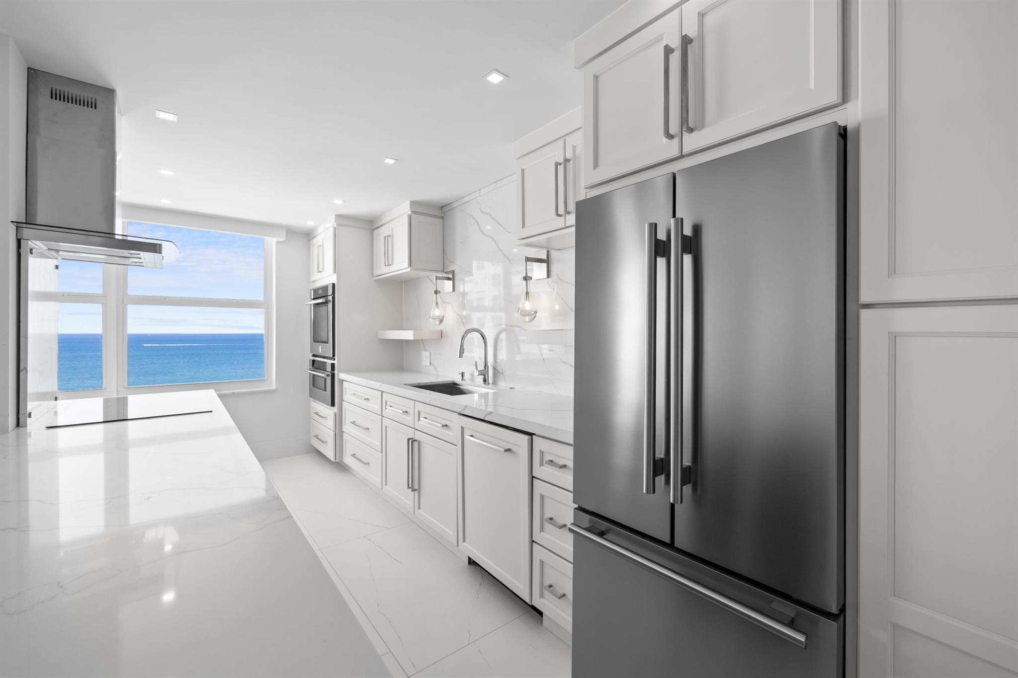 Welcome to Residence 15D at the prestigious Plaza East on Fort Lauderdale's Famous Galt Ocean Mile. This fully renovated 2-bedroom, 2-bathroom oceanfront residence offers breathtaking, unobstructed views of the Atlantic Ocean and Intracoastal Waterway from the 15th floor. Thoughtfully designed with high-end finishes and custom features throughout, this home combines modern coastal elegance with luxury living. The open-concept kitchen is a showstopper, featuring custom white shaker cabinetry, premium Forno European-designed stainless steel appliances, quartz countertops, and a stunning waterfall-edge peninsula ideal for entertaining.