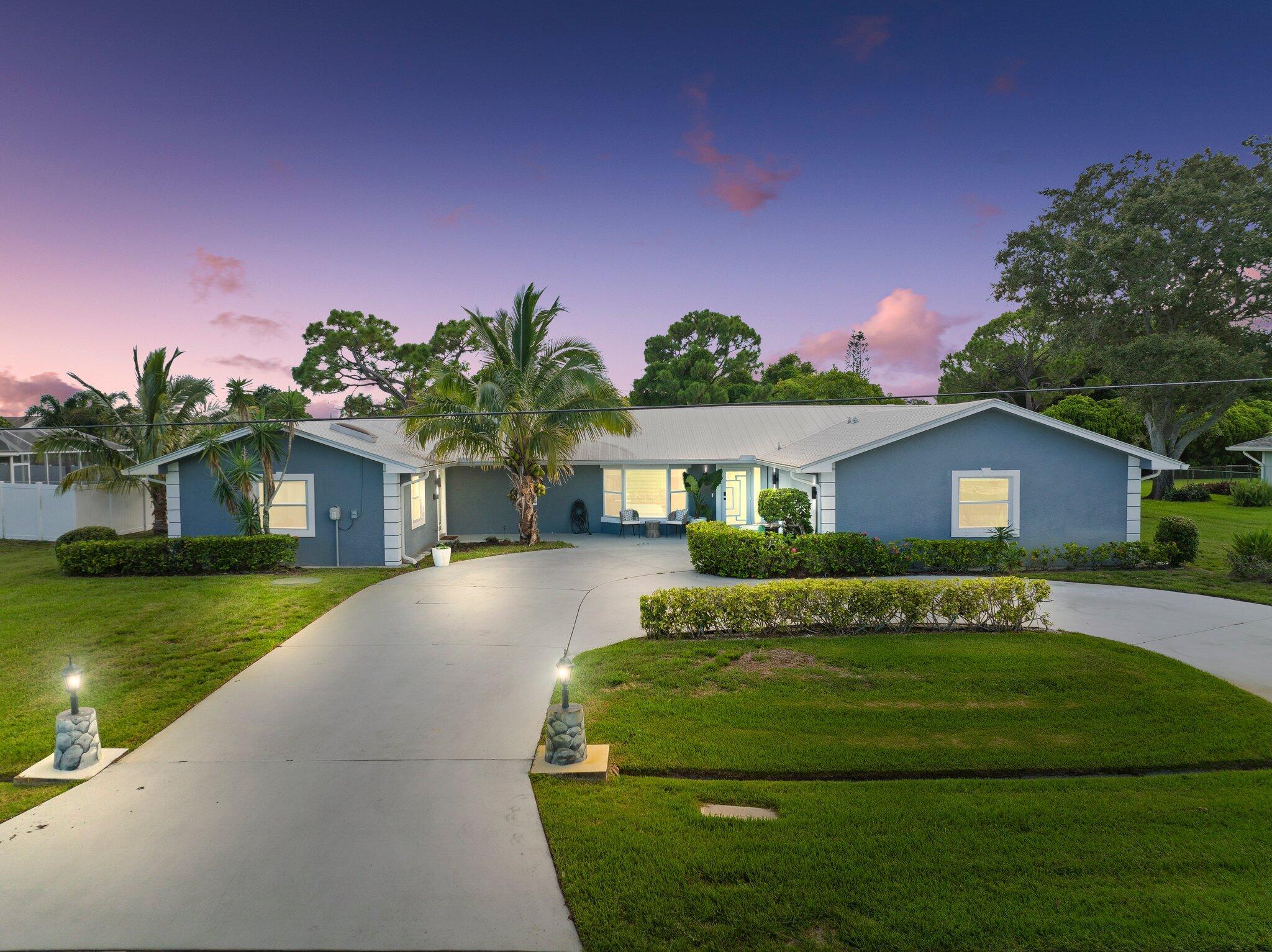 Discover the essence of Florida living nestled on a generous 0.44-acre lot. A circular driveway welcomes you to this stunning property with a blend of comfort and style. This 5 bed, 4 bath home features a metal roof, impact windows, and tile flooring throughout. Step into a brightened living room with a bay window for natural light, a spacious kitchen with plenty of storage, granite countertops, and stainless steel appliances. The primary suite features a walk-in closet and en-suite bath. Make your way outside to a screened-in, heated pool & spa. Have guests staying over? A Bonus mother-in-law suite with private entrance, open layout, and full kitchen is at your fingertips! Lush fruit trees complete this one-of-a-kind home. Your private retreat awaits!
