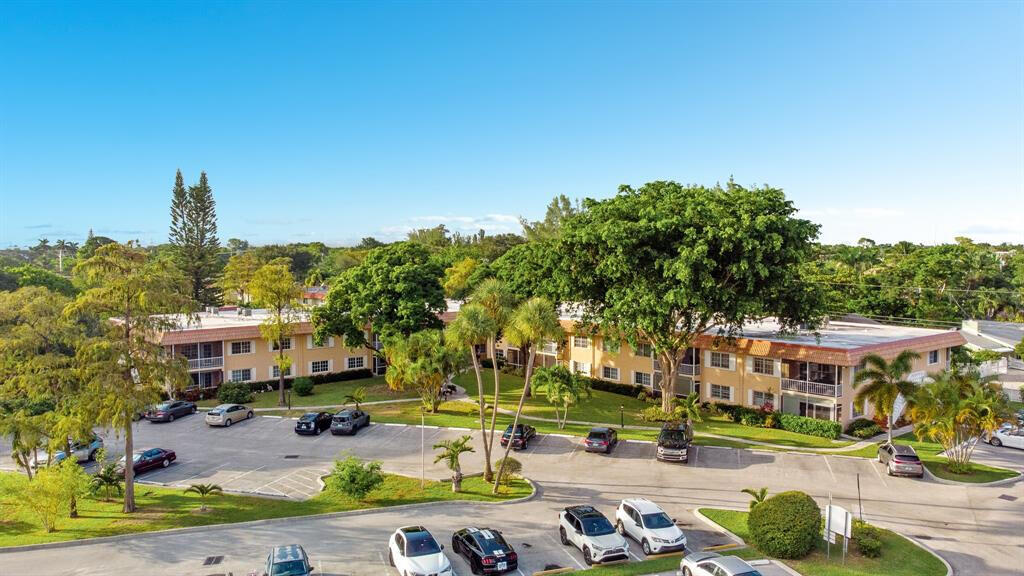 Do not miss this remodeled 2/2 condo in Manor Grove Village IV, an impeccably maintained community in the heart of everything! This unit comes with 2 parking spots and only a short walk to Wilton Manor's restaurants, shops, and nightlife and features new wood flooring, new paint, new kitchen cabinets & quartz countertop. NEW IMPACT WINDOWS/DOORS throughout. Lots of storage throughout and spacious primary bedrom with walk in closet. Relax on your peaceful screened patio or enjoy resort-style amenities including a heated pool, sauna, tennis and pickleball courts, gym, clubhouse for social functions, and grilling. Monthly HOA fees are $730.25, plus $92.19 for cable and internet. Live like you are on vacation year round!