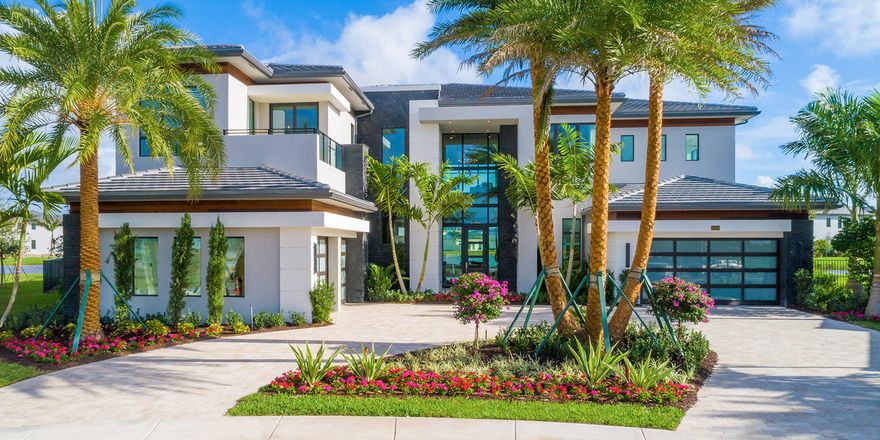 Contemporary estate on a magnificent point pie lot with spectacular lake view in Boca Bridges! This Vanderbilt Grande features 6 en suite bedrooms, game room with custom built in bar, home office, loft, media room and 4 car garage with glass doors. The backyard is made for entertaining with a summer kitchen, large covered patio and a custom pool with floating steps, a sun deck and integrated spa. The living room features a marble dual sided fireplace and custom glass wine closet. The fabulous master suite has a covered balcony, sitting area and dual contemporary baths. Additional highlights include: 12' impact glass entry door with floor to ceiling glass wall, foyer floor to ceiling feature wall, glass stair rail, family room sliders with full corner opening and marble circular driveway.
