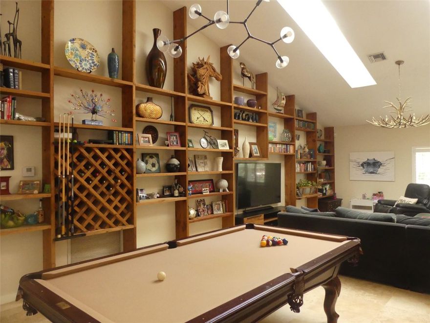 Rare Country Acres estate offering true acreage living in Parkland. This sprawling ranch-style home features a split-bedroom layout with travertine and marble floors, a dramatic Chicago brick three-opening fireplace, custom cedar built-ins, semi-formal formal dining room, and a generous primary suite with walk-in closet and dual sinks. Updated kitchen (2016) with granite counters and 4-burner cooktop. Resort-style outdoor living includes a pool with travertine deck, spa, party pavilion, cabana bath, outdoor kitchen, screened patio, metal roof, and on-site barn. Zoned A-1 Agricultural-Residential allowing horses, equestrian use, and agricultural activities. No HOA, low inventory area, and strong long-term value in one of South Florida’s most desirable communities. 5221 Pinetree Rd, Parkland presents a rare opportunity to acquire an estate-scale residence in the highly coveted Country Acres enclave, offering a unique combination of architectural character, resort-style amenities, and one of Parkland’s most valuable zoning designations. This sprawling ranch-style home features a highly functional split-bedroom layout with travertine and marble flooring throughout, a dramatic Chicago brick three-opening fireplace serving as the focal point of the living room, custom cedar built-in shelving lining the entire back wall, a separate formal dining room, and a generous primary suite with a large walk-in closet and dual-sink bath. The updated kitchen (2016) is appointed with granite countertops and a four-burner cooktop, while the 2.5-car garage offers vinyl tile flooring and extensive built-in cabinetry. Designed for year-round enjoyment, the outdoor living areas include a large heated pool with self-chlorinator, travertine marble pool deck, outdoor spa, party pavilion, full cabana bath, outdoor kitchen, and screened patio, all set within expansive grounds improved with a durable metal roof and an on-site barn. Located within the broader residential fabric of Parkland, the property benefits from proximity to top-tier schools, amenities, and the city’s renowned community character, while its A-1 Agricultural-Residential zoning allows for equestrian use, horses, stables, barns, paddocks, and a wide range of agricultural activities including hobby or commercial farming, nurseries, orchards, and gardens—an increasingly scarce entitlement in Broward County. This zoning provides meaningful long-term value through land scarcity, lifestyle flexibility, privacy, and future optionality, aligning with Parkland’s low-density, preservation-focused planning philosophy. Country Acres continues to outperform the broader Parkland market in pricing and price per square foot due to tight inventory and strong demand from estate, equestrian, and agricultural buyers, making 5221 Pinetree Rd a compelling opportunity for purchasers seeking true estate living in one of South Florida’s most controlled and desirable municipalities.