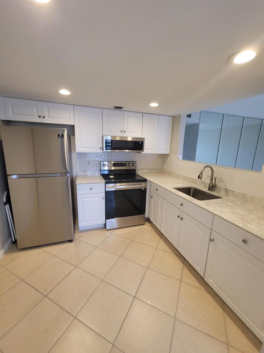 Spectacular Lake Views from your Lanai with access from both bedrooms. Ceramic Tiles throughout the condo extending to the lanai area. Updated Kitchen with Stainless Steel Appliances, recess lighting and custom window treatments in all rooms. All newly Installed Hurricane Impact Windows. Both bathrooms have been renovated with walk-in showers and an abundance of extra storage in the unit. 
Enjoy all the amenities of Century Village 55+ Adult Community: physical fitness, dancing, shows, educational classes, also an indoor swimming pool and spa! In addition Century Village offers shuttle buses to many places. Century Village is close to the Turnpike, 5 minutes to I-95. City Place downtown upscale shopping, the Intracoastal and the PBI Airport. Call today for your VIP Visit!