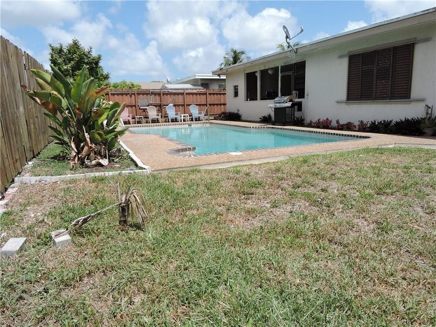 Perfect home for entertaining.  Covered patio with built-in bar.  Large pool with wooden pool deck and a lawn big enough for a play area for the kids.  Separate family room with built-in wall shelving.  Kitchen has pass through window and open counter to host a large family dinner.  No carpet only laminate floors throughout. Separate laundry room under air.  One car garage.  Circular driveway that accommodates 3 cars easily.  Quite neighborhood.