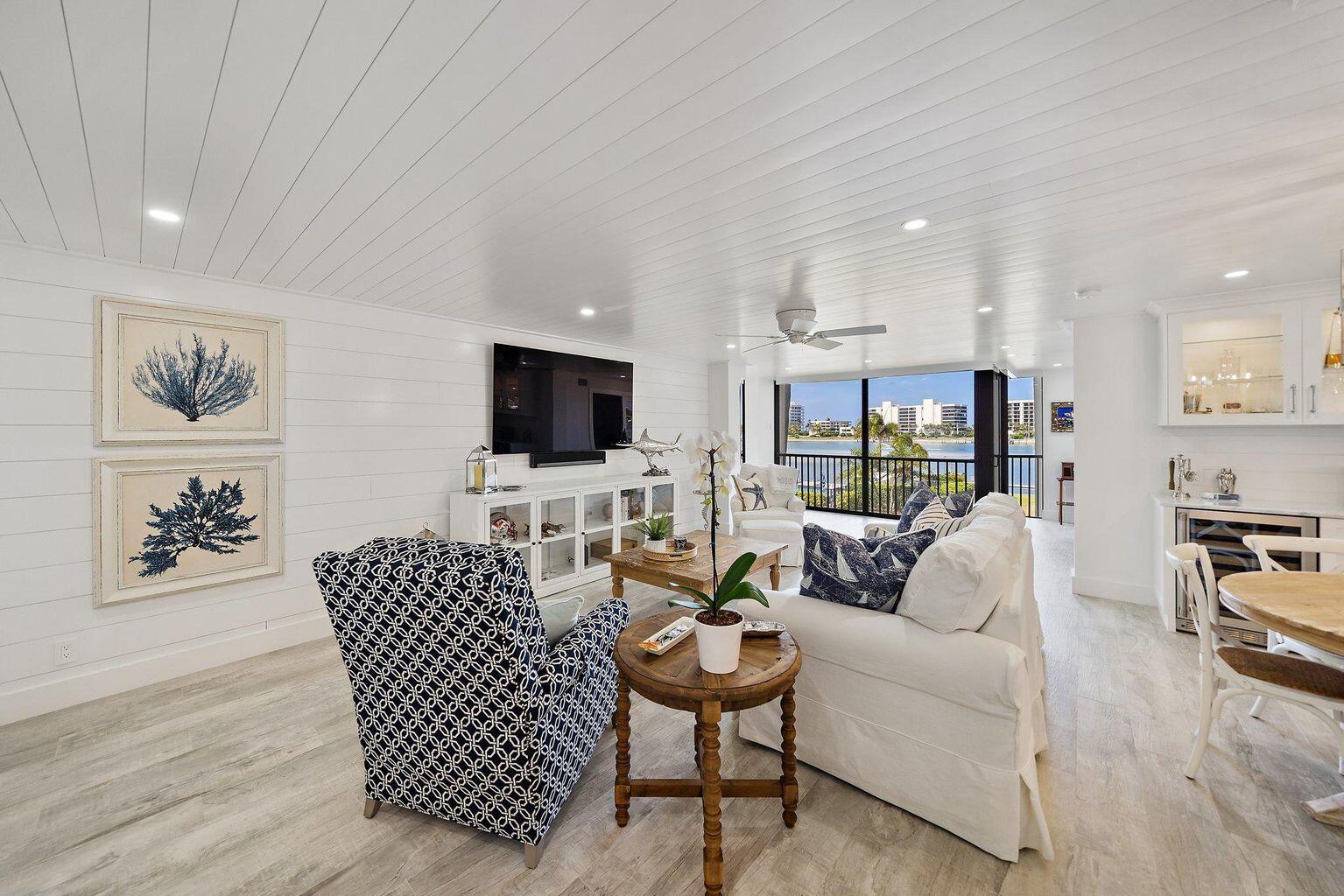 Completely renovated coastal-styled condo with unobstructed Caribbean blue Intracoastal views! Offered turnkey furnished, including designer furnishings, artwork, linens and fully outfitted kitchen. The architecturally re-imagined floorplan offers a split bedroom design, custom bar and service area with backlit, glass paneled cabinetry, dual beverage coolers, gorgeous quartzite countertops and upgraded stainless appliance package. Move right into this light and refreshing home and instantly sense the luxurious south Florida lifestyle it offers. Amenities include a day dock/fishing pier, sandy beach areas for kayak and paddle board storage, inside bike and board storage, tennis courts, heated pool right next to the Intracoastal Waterway, community Weber grills and a modern clubhouse