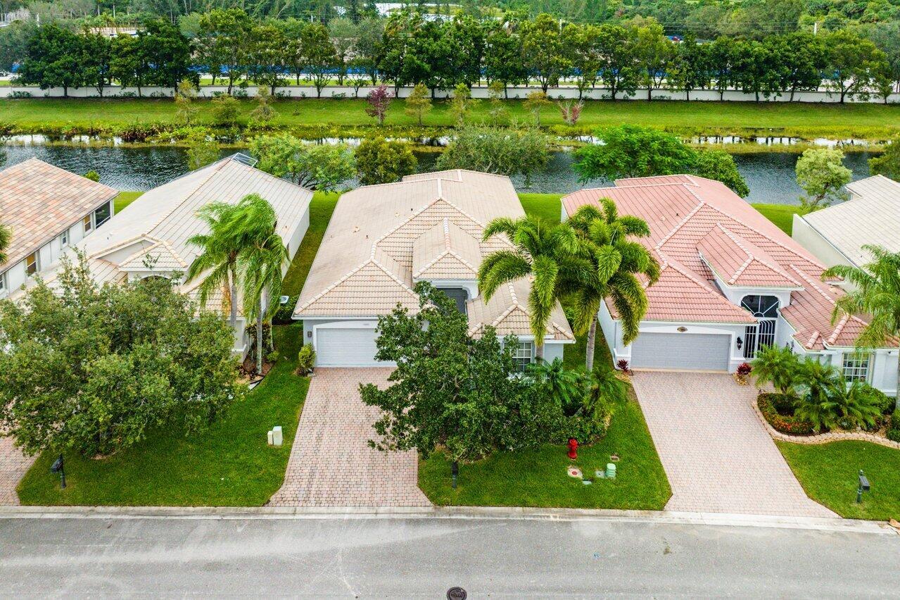 Welcome to Bellaggio! One of the most sought after premier 55+ communities in Palm Beach! If you're looking for an upscale high end resort style community then you are in the right place at the exact right time! This gorgeous home features an abundance of space with an open floor plan, tile floors, updated light fixtures, stainless steel appliances, luxury vinyl plank floors in the bedrooms and an abundance of natural light beaming through the home! This home offers you a phenomenal view of the water as well as plenty of privacy out back! Bellagio is full of extraordinary amenities that you don't typically find anywhere else. You have a 24 hour manned security gate, indoor/outdoor pool, tennis, pickleball, clubhouse, fitness center, billiards, and the events are AMAZING! You have to see!