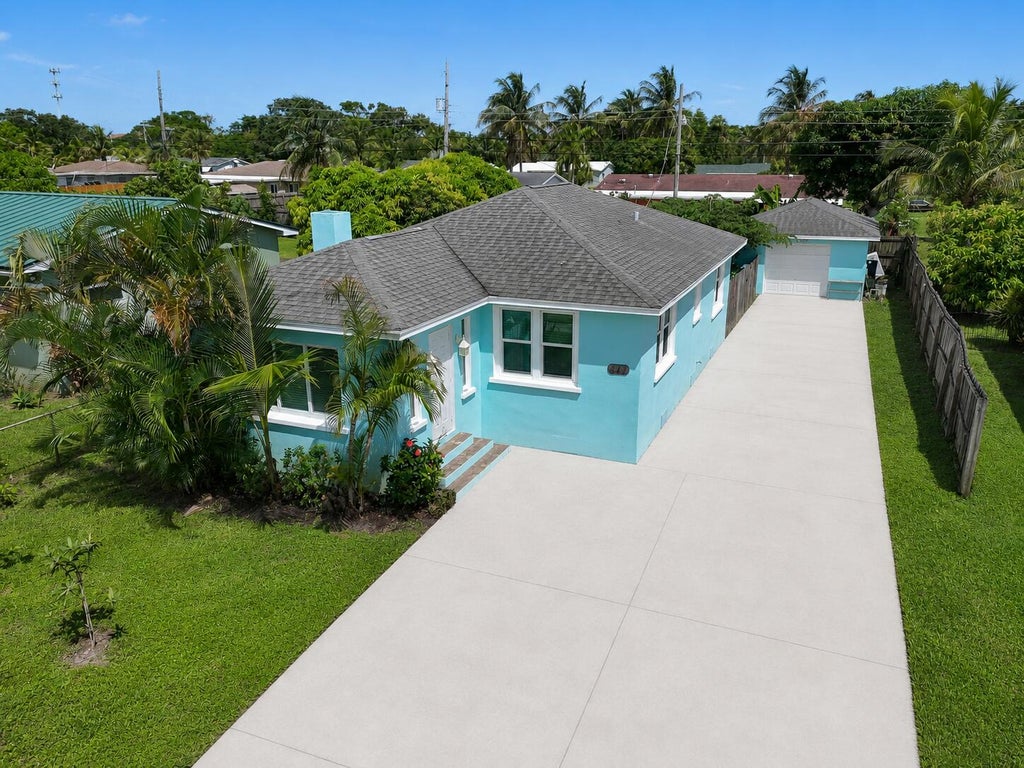 Photo of 411 Evergreen Drive, Lake Park, FL 33403 (MLS # B26071800)