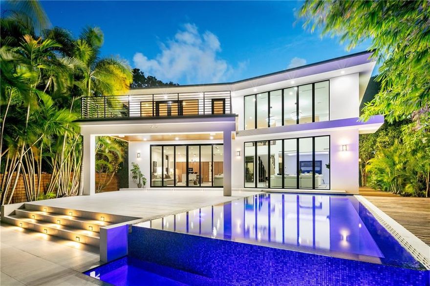 Luxurious modern mindfully crafted waterfront estate with lush tropical landscaping including an indoor garden.  Privately gated and sited on an over-sized 16,707 sqft lot with serene views of Seminole Lake.  Boater friendly, no-wake, deep water, powered dockage for a 50+ foot vessel and no fixed bridges.  Smart home equipped with control 4 technology, electric car charger, and solar power system. Other features include 6 en suite bedrooms, a 1200 sqft primary, wrap around driveway with parking for 15+ cars, home theater, office space, infinity pool, outdoor kitchen, 20 ft. ceilings, multiple balconies, and a built in wine rack.  Bayview Elementary school district with close proximity to parks, Galleria Mall, beach, boat launch, and fine dining.