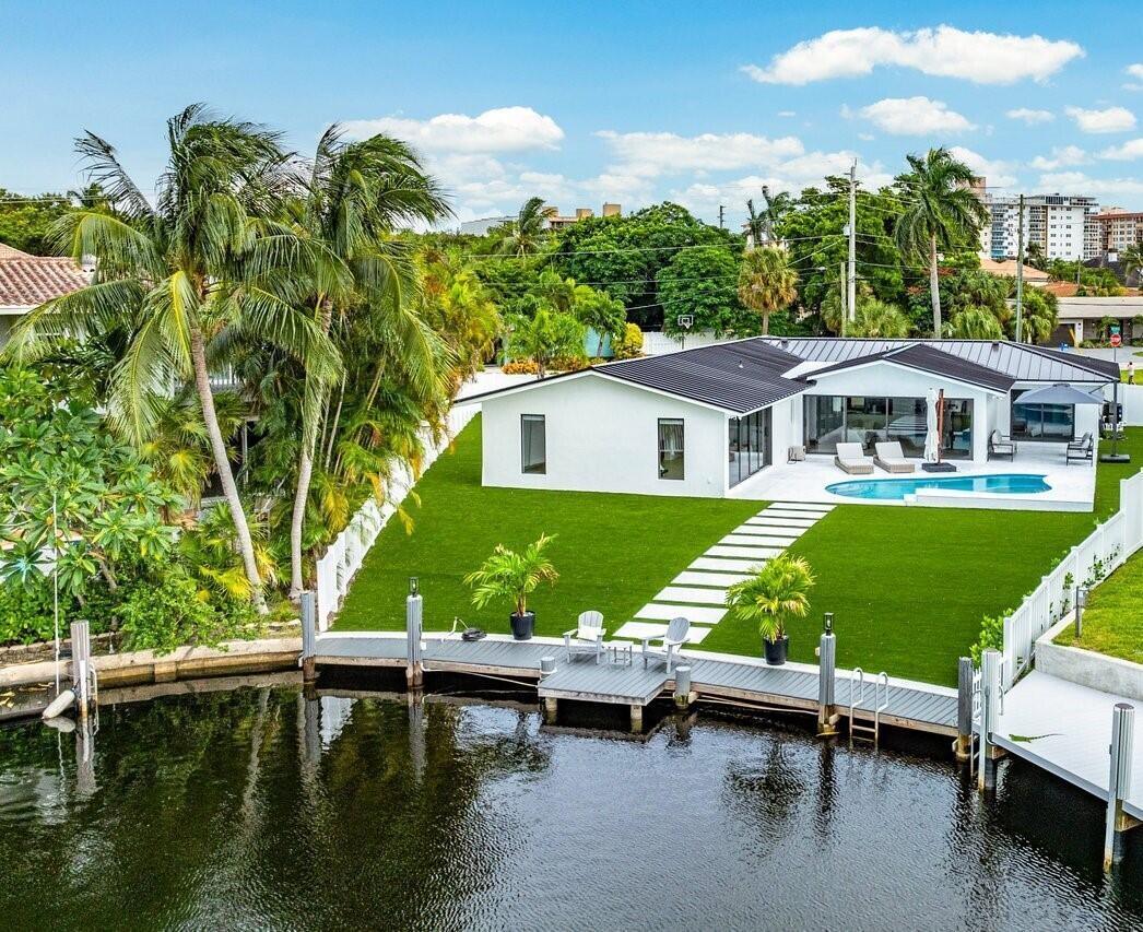 ABSOLUTELY MINT and PRICED TO SELL! One-of-a-kind opportunity to own this Coastal-Inspired Deepwater Estate sited on 49' +/- of waterfrontage on a 14,274 sq ft lot with no fixed bridges in Lighthouse Point. This 3 bedroom/3 bathroom single family home has been completely remodeled on one of the largest lots offered in the area. Split floor plan, Italian porcelain tile floors throughout. Bright, open kitchen with European flat cabinets quartz countertops, and brand new appliances. Oversized master suite with 2 walk-in closets, large freestanding tub, and curbless walk in shower. BRAND NEW METAL ROOF, NEW AC's & brand new impact windows & doors with huge pocket sliders leading out to the resort style backyard that includes a fully remodeled heated pool/spa with sandblasted marble deck.