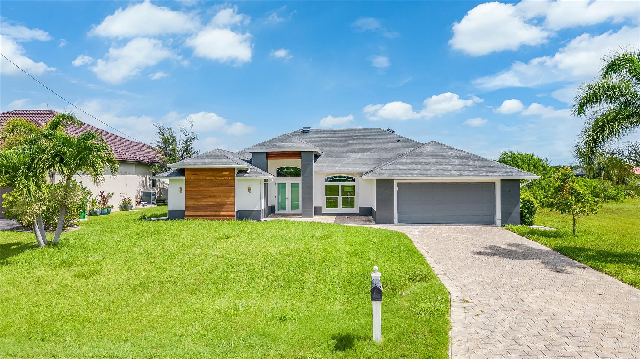 Experience waterfront Gulf Access living with this spacious 3-bedroom, 2-bathroom pool home spanning 2,300 sq. ft. Enjoy stunning intersecting waterway views from a wide canal location, offering direct Gulf of Mexico access. Outside, a private oasis awaits with a pool, dock, and lift. The fully renovated interior features elegant tile flooring a Sunlit living spaces offer warmth for relaxation and entertaining. The chef’s kitchen boasts new, custom cabinetry, and granite countertops. Retreat to the master suite with water views and a stylish ensuite. Two guest bedrooms ensure comfort for all. A newly paved driveway leads to the attached garage. Located in Cape Coral near shopping and dining—schedule your showing today!