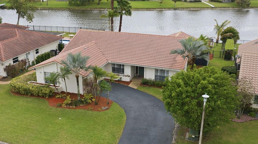 NO HOA -waterfront pool home situated on an oversized 11,000+ sq ft lot! This 4 bedroom, 2 bathroom residence features volume ceilings and a spacious layout with formal living and dining room. The large open kitchen offers granite countertops, SS appliances, dual oven, and ample cabinet space—perfect for entertaining. Plantation shutters throughout add a touch of elegance, while major updates include a 6-year-old A/C and tankless water heater. Both bathrooms feature dual sinks for added convenience. Step outside to your private backyard oasis with a resurfaced pool (3 years old) overlooking the water. Large driveway to fit 4+ extra cars and 2-car garage provide plenty of parking. no HOA—bring your boat, RV.  A great opportunity to own a well-maintained waterfront-pool home.