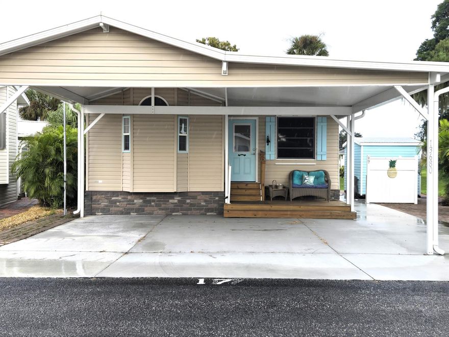 BLUE CYPRESS GOLF & RV RESORT:  Meticulous 2014 home offers 1 bd 1 ba w/908 sf & 3,031 total sf.  Living Room features large windows overlooking golf course, impact entry door and ceiling fan.  Kitchen has newer appliances, including DW.  Bdrm features built-in storage & ceiling fan. Walk-in shower.  Bonus room can be used for office, craft or 2nd bdrm.  Temporary wall can be removed to add addtl living space.  Indoor W/D.  8x10 shed provides addtl storage/workshop.  Slab walk way & pavers allow for outdoor living space.  Perfect location for golfers and boating enthusiasts.  Dock space & boat ramp available providing access to Lake Okeechobee.  Community offers newer pickleball court, clubhouse, shuffleboard court & pool.  This home has been exquisitely decorated and comes furnished.