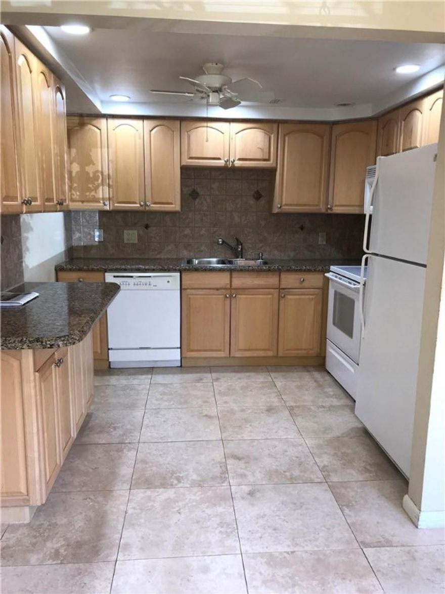 UPDATED, GROUND FLOOR LUXURY 2/2 in highly desirable Grantham delivers again with this 1st floor beauty!  Renovated flooring, kitchens and bathrooms give this condo a great move-in ready comfort with granite eat-in kitchen counter tops, white appliances, recessed lighting and wood cabinets with extra storage! Neutral tile throughout (including patio), updated electrical panel, both bathrooms have stalls showers with sliding glass doors and vanities with extra storage.  Built-ins in master closet, enclosed patio boasts a lovely garden view, roll-up hurricane shutters AND a back door!  PRICED TO SELL!