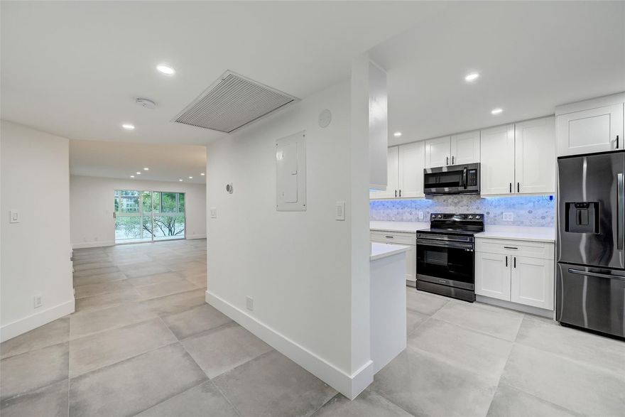 PERFECTION IS HERE! BEAUTHFUL IRIS MODEL 2 BED 2 BATH WILL IMPRESS THE MOST DISCRIMINATING BUYER WITH ITS BEAUTIFUL UPGRADES, OPEN & SPACIOUS PLAN. ENJOY MORNING COFFEE OR EVENING GLASS OF WINE WHILE RELAXING ON BALCONY OVERLOOKING PEACEFUL LAKE VIEWS. ABSOLUTELY STUNNING MODERN INSPIRED PORCELAIN FLOORING THROUGHOUT, LUXURIOUS KITCHEN CABINETRY, QUARTZ COUNTERTOPS, AND STAINLESS STEEL APPLIANCES. ALL NEW IMPACT WINDOWS AND DOORS, NEW WATER HEATER, NEW EVERYTHING! RENOVATION WORK COMPLETED WITH CITY PERMITS! WYNMOOR IS A RESORT STYLE COMMUNITY FEATURING AN 18-HOLE EXECUTIVE GOLF COURSE, PICKLEBALL, TENNIS COURTS, FITNESS CENTER, THEATRE, COURTESY BUSES, COFFEE SHOP, RESTAURANT, STATE OF ART WOODWORK SHOP, STAINED GLASS KILN, POOL, BILLIARD TABLES & MUCH MORE.