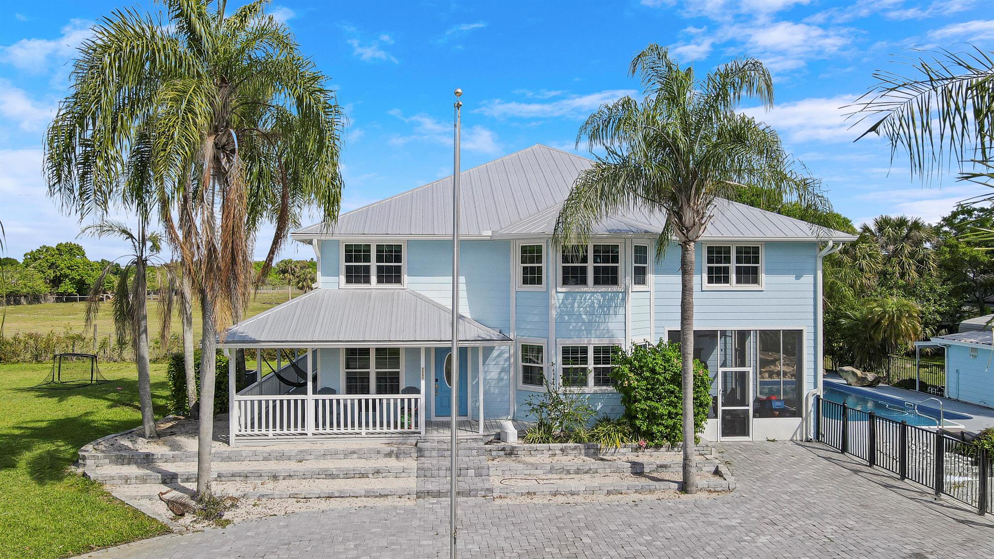 6 Bedroom 4 Bath pool home with 2 additional half baths and located on a huge 2.2 acre completely fenced lot with storage shed, oversized carport and pole barn for horses, cattle, chickens and more! Covered, wrap-around porch surrounds the home with beautiful landscaping and a pergola with plenty of room to entertain and enjoy the good life in Okeechobee! Light and bright completely updated kitchen with Quartz Countertops and stainless steel appliances, tile throughout, foam insulation and impact windows. Large loft/bonus room or playroom, office or den. So many possibilities to spread out!