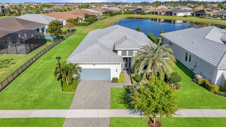 An extraordinary expression of lakefront luxury in one of Westlake's premier 55+ communities. This impeccably designed 3BR/3BA home offers over 2,900 sq ft with sweeping long lake views and a refined, contemporary feel. Move-in ready and loaded with upgrades, it features engineered wood flooring, impact windows, and an expanded primary suite. The designer kitchen showcases quartz waterfall countertops, sleek cabinetry, and gas cooking—ideal for entertaining. Spa-inspired baths include floor-to-ceiling tile and semi-frameless glass. Enjoy resort-style amenities: clubhouse, pool, fitness center, tennis, pickleball, billiards, and more in this award-winning community.