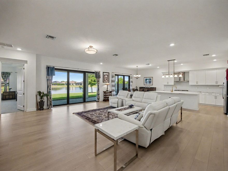 Why wait months to build when your dream home is ready right now? Welcome to 5353 Siesta Key Lane in Cresswind—an exceptional, move-in-ready residence nestled in one of the area's most vibrant and active communities.  This stunning spec home offers nearly 3,000 square feet of thoughtfully designed living space, loaded with high-end upgrades throughout. From the moment you enter, you'll notice the elevated finishes, including beautiful quartz countertops, a sleek gas stove, and a modern tankless water heater for efficiency and comfort.  The open-concept layout is perfect for both everyday living and entertaining, seamlessly connecting spacious living areas with a chef-inspired kitchen. Step outside to your extended lanai and take in the breathtaking long lake views.