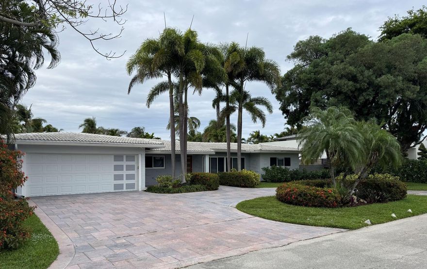 Located in the highly desirable Bayview Elementary School district, this beautifully maintained one-story pool home offers 4 bedrooms, 3 bathrooms, and approximately 2,200 square feet of thoughtfully designed living space. Its unique U-shaped layout maximizes indoor-outdoor living, with nearly every room enjoying direct access to and views of the private pool. The open-concept living, dining, and kitchen area features vaulted ceilings, architectural lighting on smart dimmers, and impact windows and sliding glass doors throughout..  Step outside to a 36-foot-wide covered lanai overlooking a fully walled lush tropical backyard oasis. The pool has been updated with a brand-new Blue Diamond Brite finish (2024) and includes a premium Gulfstream heater   (most efficient in the industry) ...more for year-round enjoyment. The fully fenced yard is surrounded by mature hedging for exceptional privacy. Additional highlights include a separate tiled utility/laundry room with ample storage, a spacious two-car garage with dual storage closets and an 18-foot impact-rated door, and a custom circular driveway with stained and stamped concrete, offering generous parking.Including low-maintenance landscaping and timed low-voltage lighting.  The primary suite serves as a private retreat with a double vanity, no-curb walk-in shower, separate water closet with its own sink, and a custom walk-in closet with built-in drawers and shoe storage. Energy-efficient features include a SEER 20 mini-split system (Within primary suite) with Wi-Fi control in addition to a SEER 16 central AC throughout, while modern conveniences such as a security camera system with app-based alerts and a recirculating pump on the water heater in the east wing enhance everyday living. This home seamlessly blends style, functionality, and resort-style comfort in one of the area's most sought-after neighborhoods.