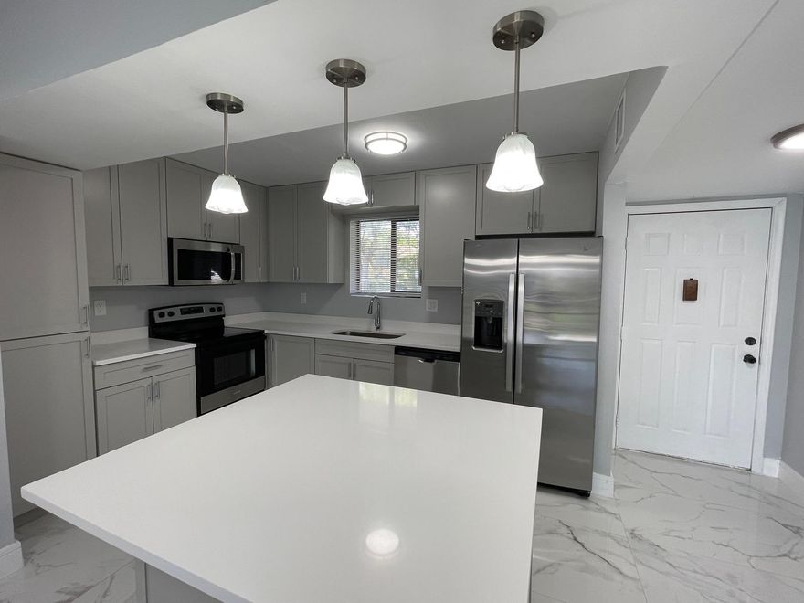 Spacious ground-floor 4-bedroom, 2-bath home in a beautiful and quiet neighborhood just west of University Drive. This updated residence features an expansive open-concept European-style kitchen, modern bathrooms, and elegant tile flooring throughout. Enjoy brand-new stainless steel appliances, fresh interior paint, and a bright, move-in-ready atmosphere. Step outside to a screened patio overlooking the sparkling pool and cabana — perfect for relaxing or entertaining. Conveniently located near Coral Square Mall, fine dining, shopping, and lively entertainment options, this home offers both comfort and convenience in an ideal location.